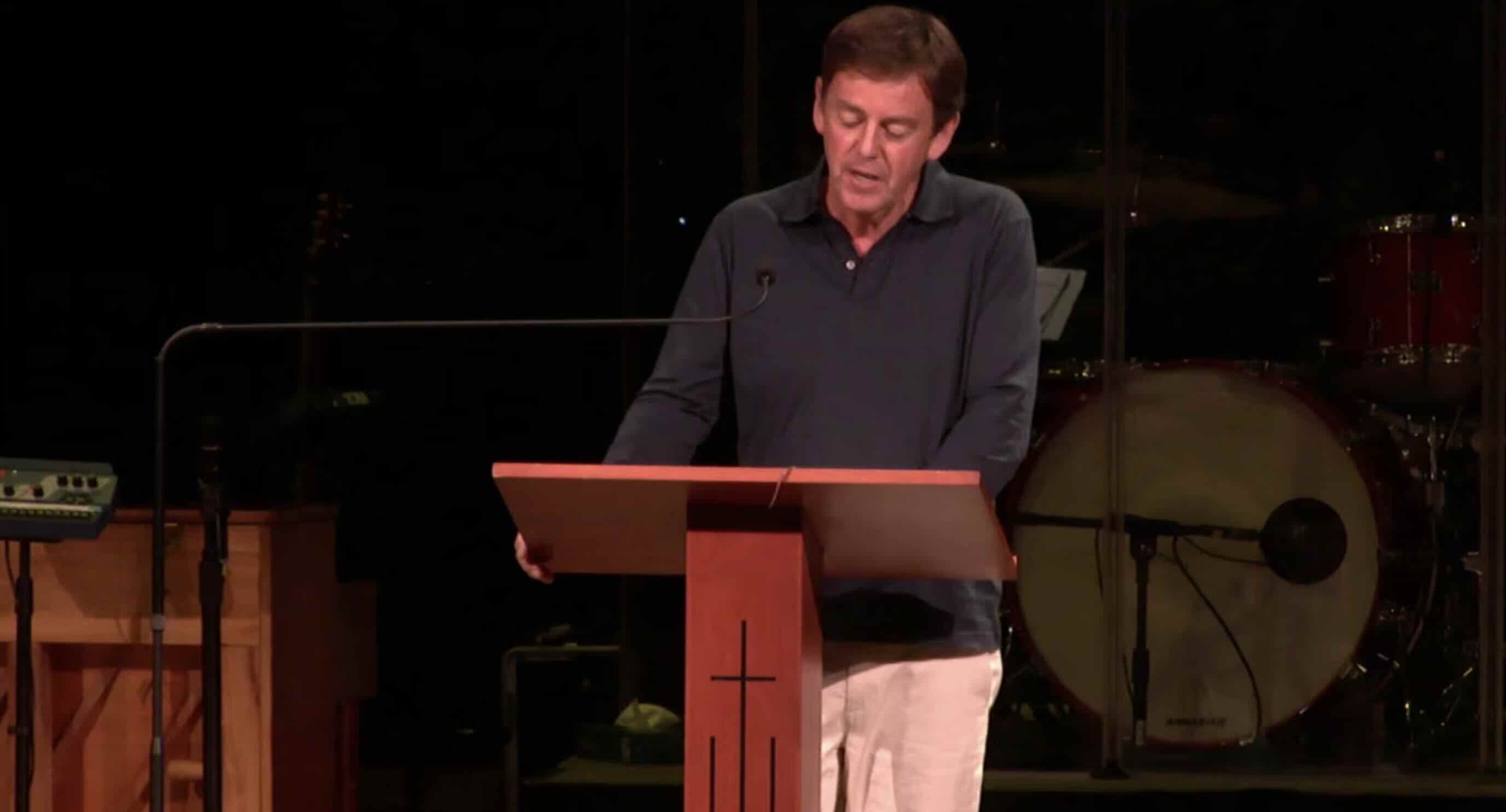 Man preaching from a simple wooden pulpit