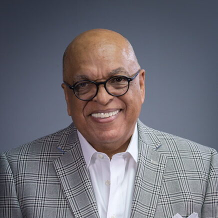 Crawford Loritts smiling in checkered suit and glasses