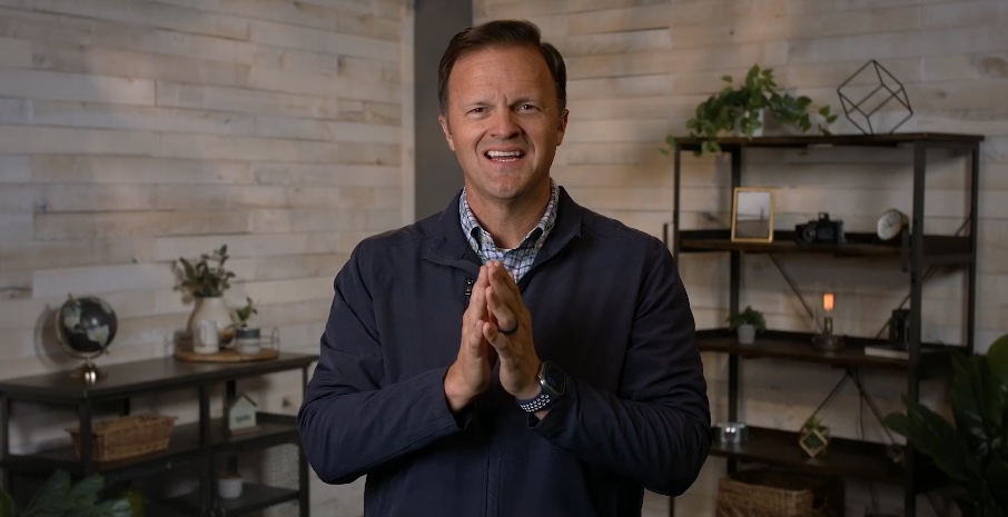 man standing welcoming with his hands together