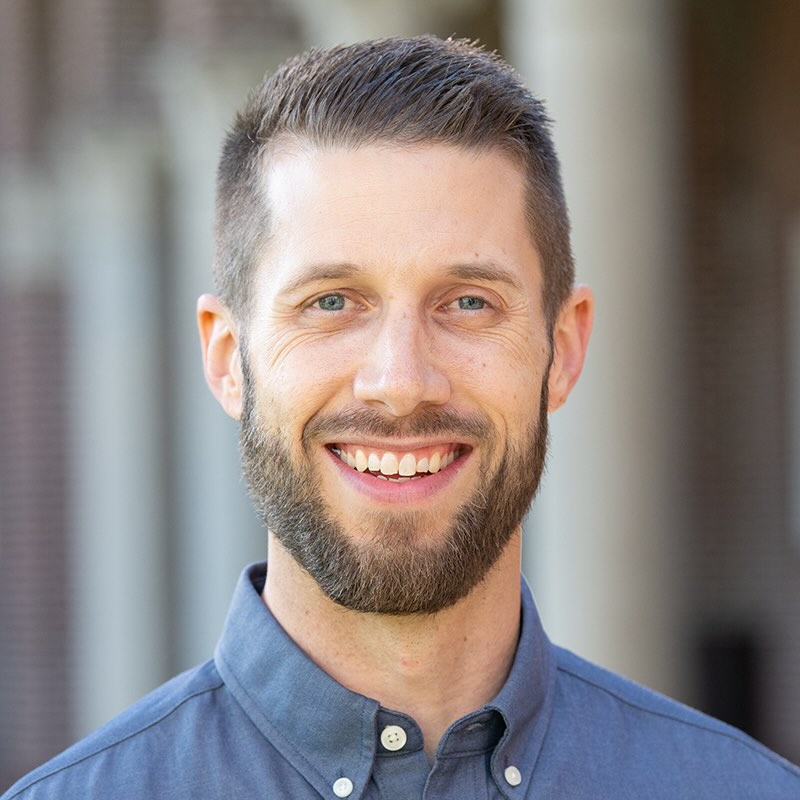 Smiling man with beard and short hair