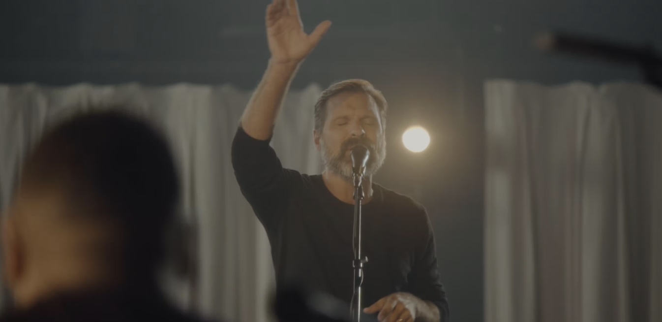 Man standing at microphone singing