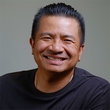 Smiling Thai Lamb in a black shirt