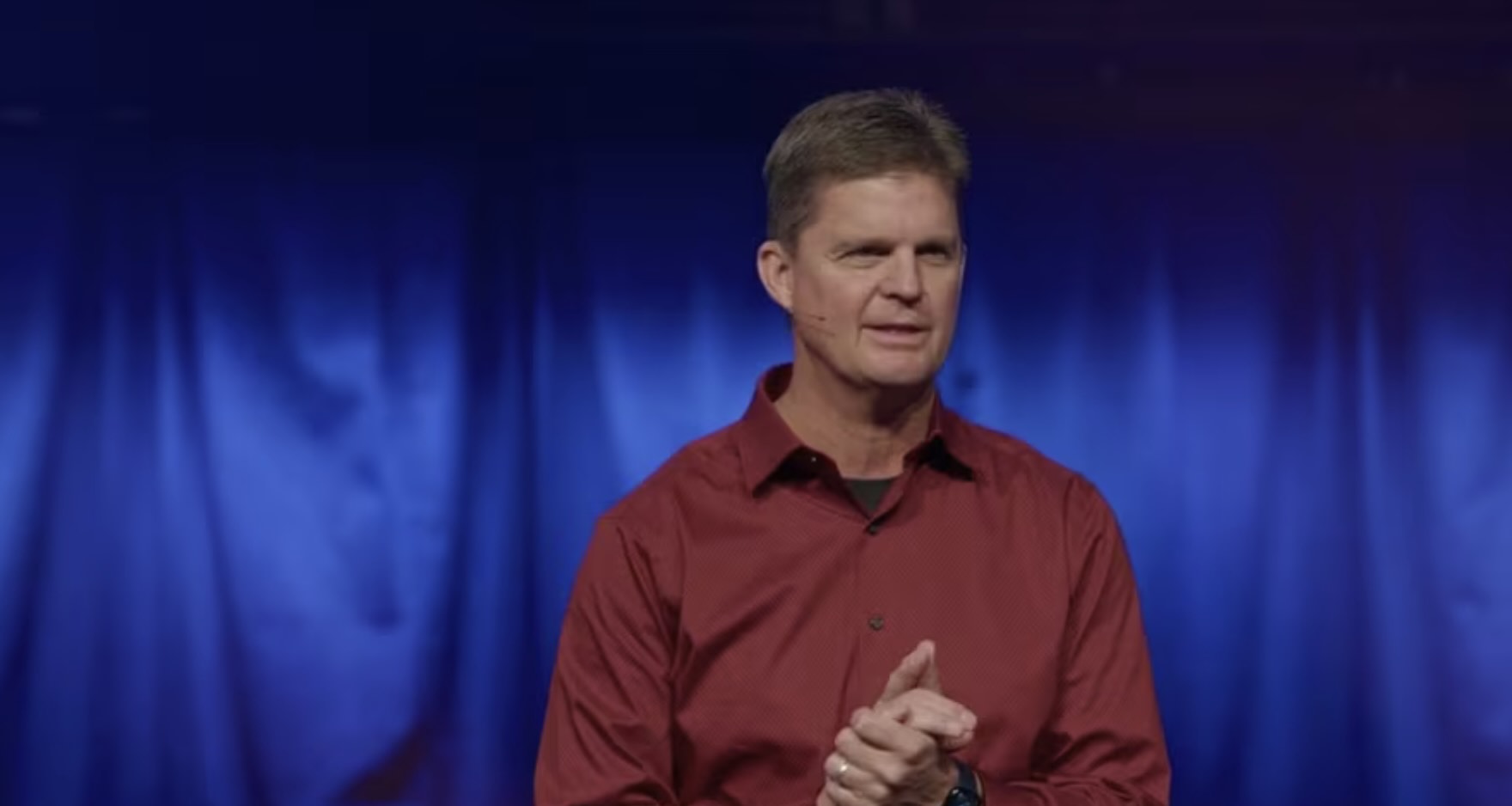 Young man in a red shirt preaching