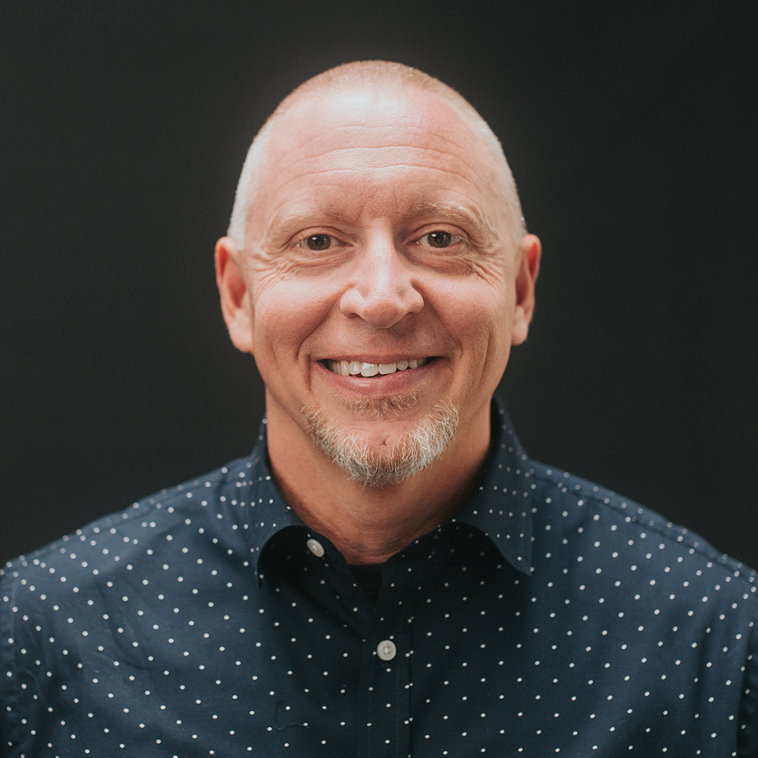Vance Pitman smiling in polka-dot shirt