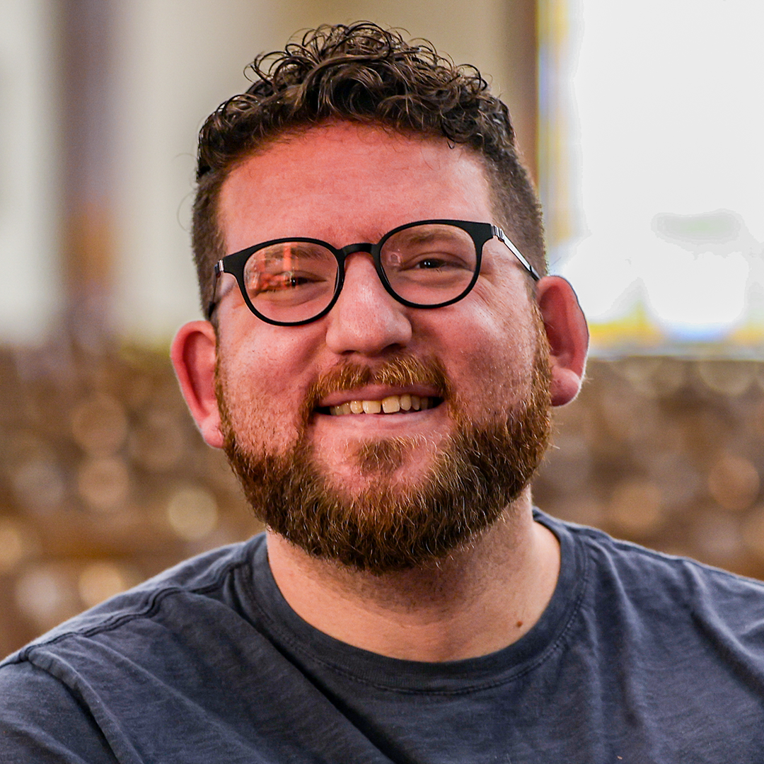 Zach Meerkreebs smiling with glasses and beard